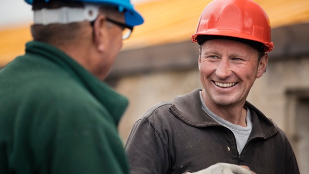 Two construction workers talking to each other