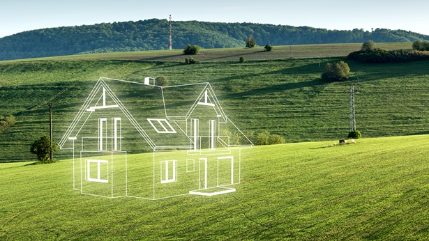 Neon outline of a house on an open field