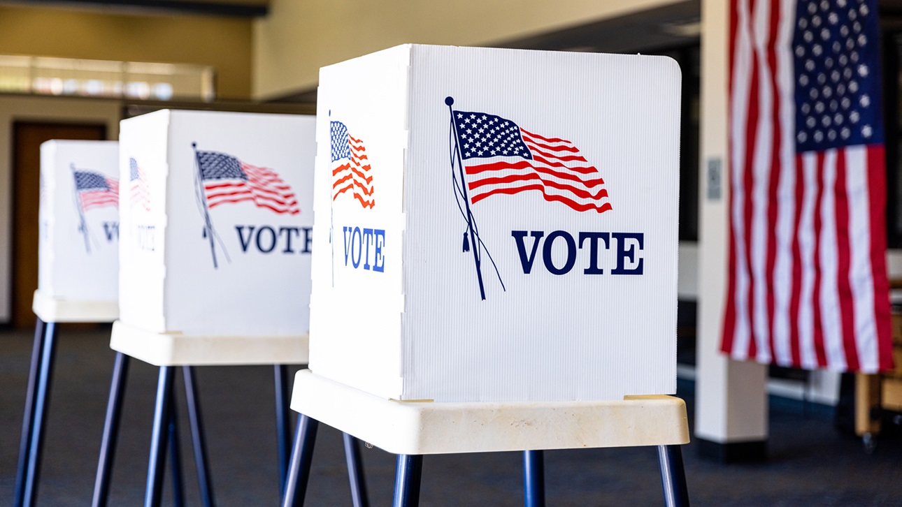 voting booths with American Flag in background